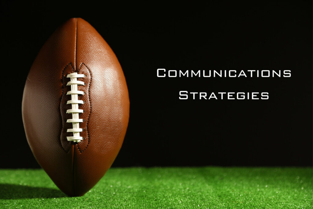 Stock image of a football with the text 'Communications Strategies' prominently displayed